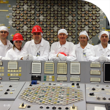 Group of seven people behind the desk of the control room at Ignalina NPP